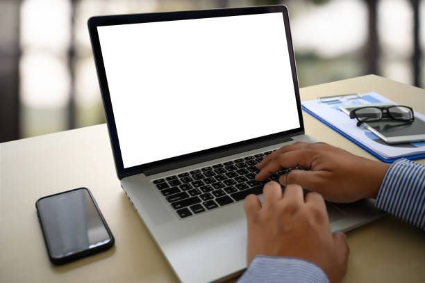istock man working on his laptop with blank copy space Laptop with blank screen Mock up Blank screen computer 1142526082
