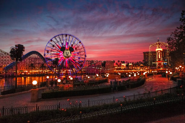 California Adventure at Sunset. Anahiem, California, USA - December 21, 2014: Tourists wander around Disney's California Adventure at dusk. California Adventure is a park located adjacent to Disneyland, a major tourist attraction in Anaheim. anaheim california stock pictures, royalty-free photos & images