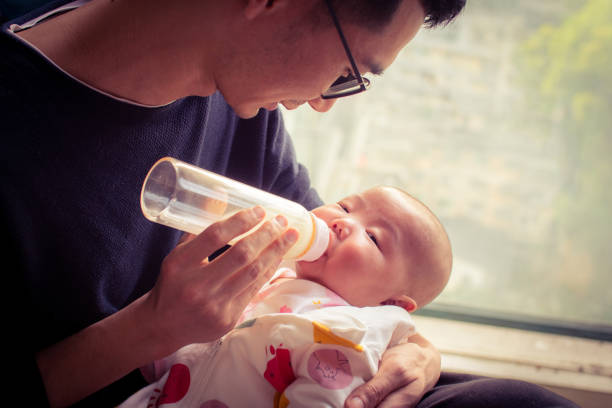 istock Baby feeding time with dad 1142530926