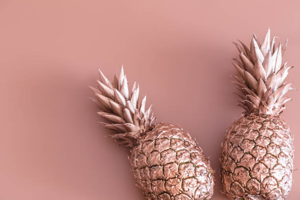 istock Gold colored pineapple on a colored background. Tropical flat lay. Food concept. 1142533401