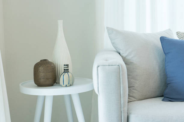 istock Ceramic vases on round table in stylish living room 1142537086