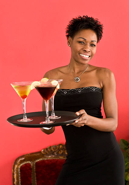 Waitress holding a tray with cocktails