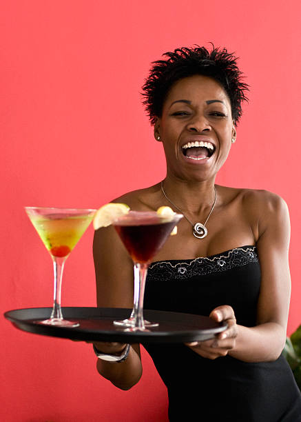 Waitress holding a tray with cocktails