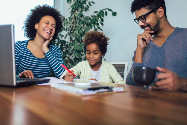 istock Mother and father helping daughter to do homework learning to calculate 1142539708