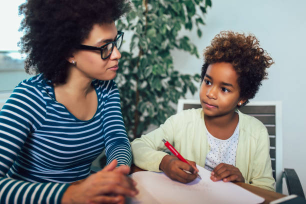 istock Mother and daughter doing homework learning to calculate 1142542121