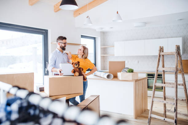 A young couple moving in new home.