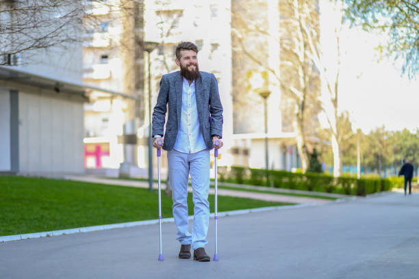 Young beautiful bearded man with walking sticks on the street. Outdoor environment