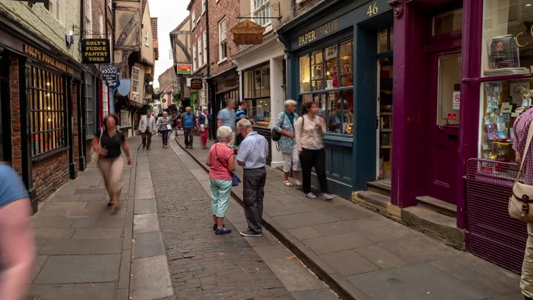 Time-lapse: Tourist Pedestrian Commuter Crowd at York shamble shopping area in York England Uk.