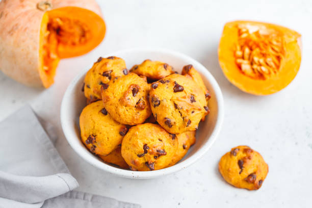 istock Pumpkin cookies with chocolate chips made from cake mix in a white ceramic bowl. 1142550309