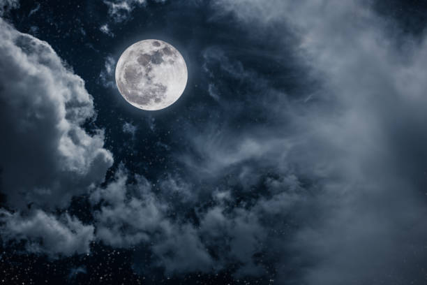 istock Beautiful dark cloudscape with many stars. Night sky with bright full moon and cloudy. 1142557416