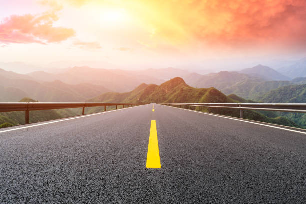 istock Asphalt road and mountains with beautiful clouds at sunset 1142558409