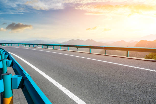 istock Asphalt road and mountains with beautiful clouds at sunset 1142558617
