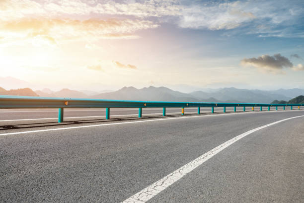istock Asphalt road and mountains with beautiful clouds at sunset 1142558625