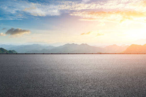 istock Asphalt road and mountains with beautiful clouds at sunset 1142558653