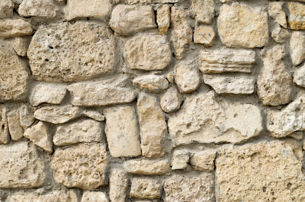istock Old relief ecru limestone wall closeup 1142558710