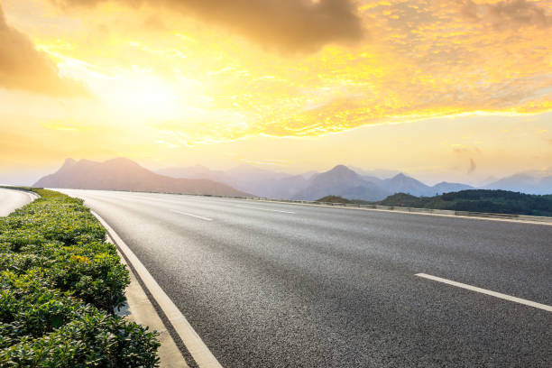 istock Asphalt road and mountains with beautiful clouds at sunset 1142558738