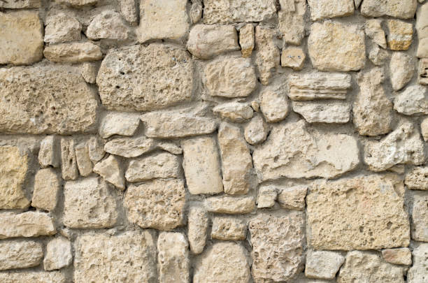 istock Old relief ecru limestone wall closeup 1142558779