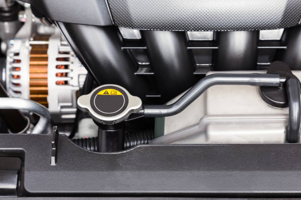 Car engine radiator cap and coolant container close-up