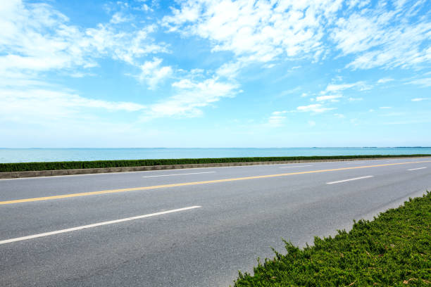 Empty asphalt road and sea with beautiful clouds landscape