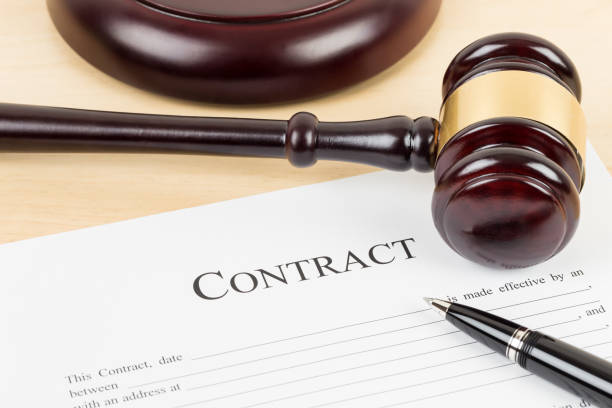 istock Wooden judge gavel with contract document and pen 1142559460