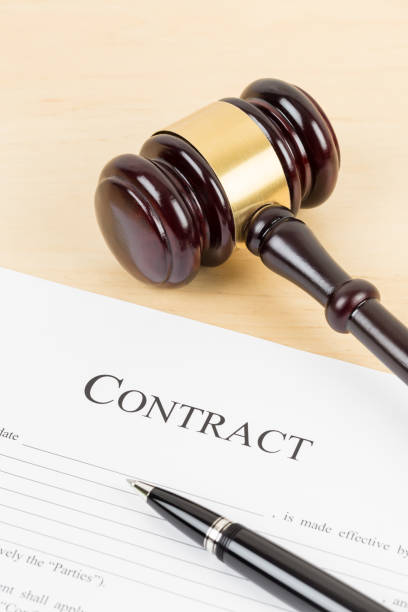 istock Wooden judge gavel with contract document and pen 1142559461