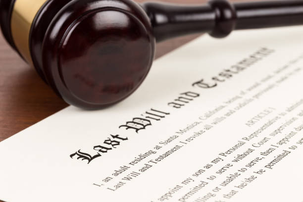 Last will and testament on yellowish paper with wooden judge gavel; document is mock-up Last will and testament on yellowish paper with wooden judge gavel; document is mock-up probate photos stock pictures, royalty-free photos & images