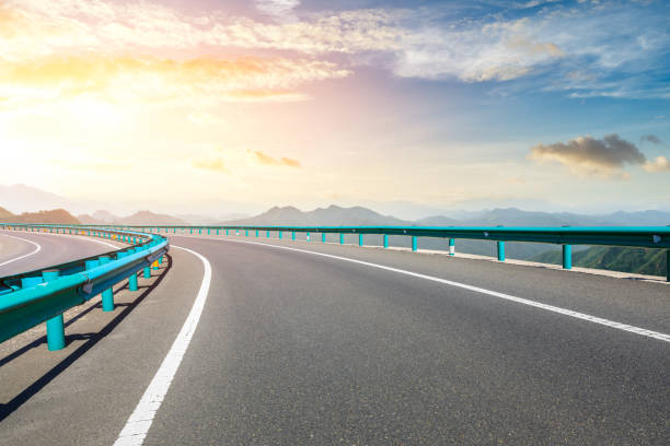 istock Asphalt road and mountains with beautiful clouds at sunset 1142559586