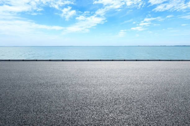 istock Empty asphalt road and sea with beautiful clouds 1142559681