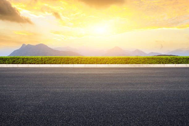 istock Asphalt road and mountains with beautiful clouds at sunset 1142559692