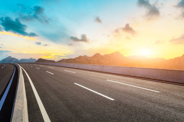 istock Asphalt road and mountains with beautiful clouds at sunset 1142559715