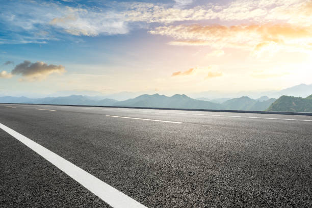 istock Asphalt road and mountains with beautiful clouds at sunset 1142559718