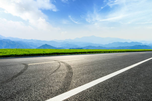 istock Asphalt road and mountains with beautiful clouds landscape 1142559771