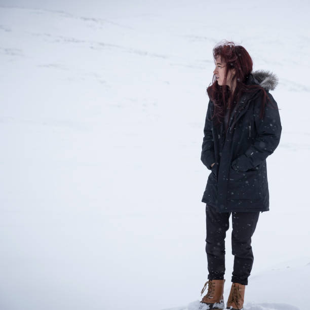 istock Young woman stands in snow 1142559831