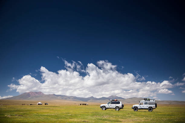 istock Trucks drive along green plane 1142559922