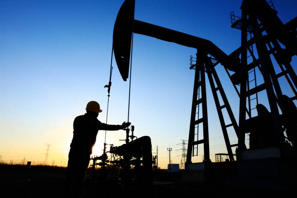 istock oil field, the oil workers are working 1142560520