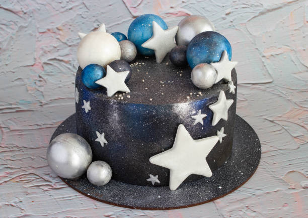 istock A cake is decorated with dark icing and stars 1142560681