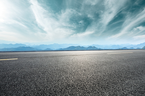 Empty asphalt road and mountains with beautiful clouds landscape