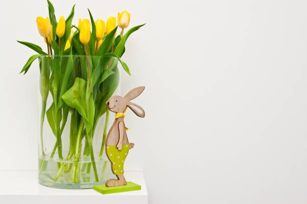 istock Yellow tulips in glass jar home decoration Easter concept 1142561294