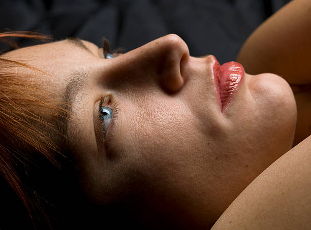 istock Side angle view of a woman lying down with her eyes open 114256270