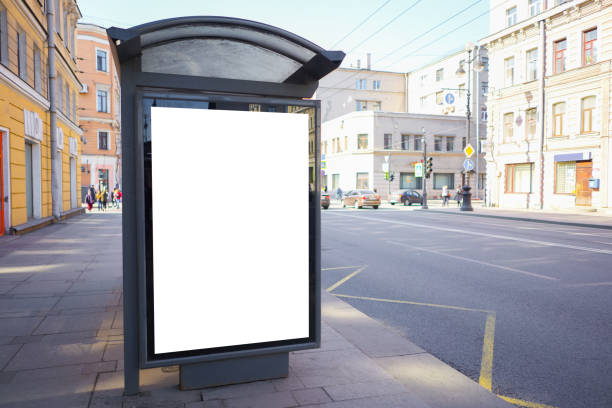 istock vertical advertising billboard ad in the bus stop. white box for placement in advertising banners. It is located in the city near the road. 1142563118
