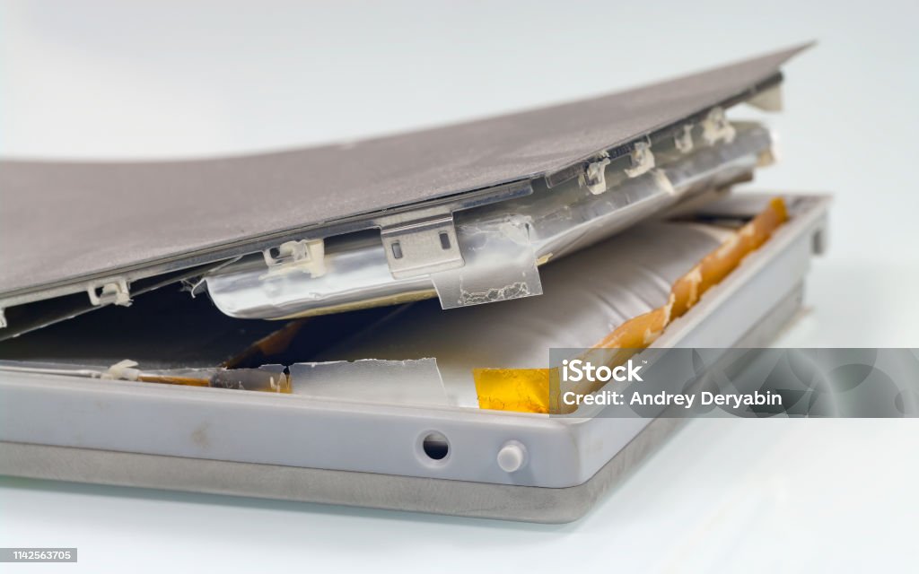 Damaged lithium-ion battery. Lithium-ion battery from laptop, which has expanded.
Battery from macbook. Lithium-Ion Battery Stock Photo