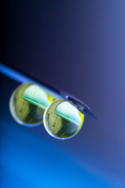 istock hypodermic needle with two drops of drug solution on his peak 1142563763