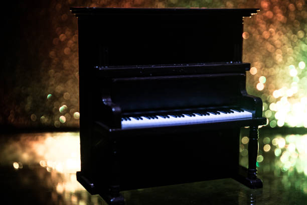istock Creative concept. Artwork decoration with piano on dark toned foggy background with light. 1142565645