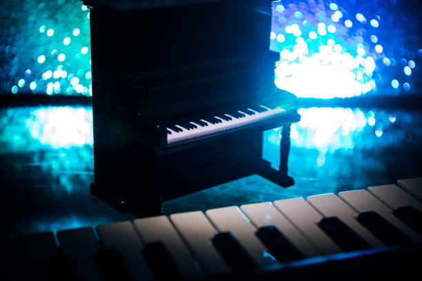 istock Creative concept. Artwork decoration with piano on dark toned foggy background with light. 1142565651