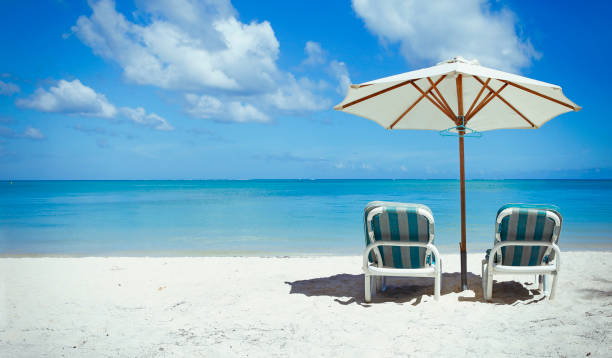 istock Perfect white beach with sunbeds and parasol 1142568230