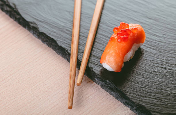 istock salmon sushi and chopsticks 1142568344