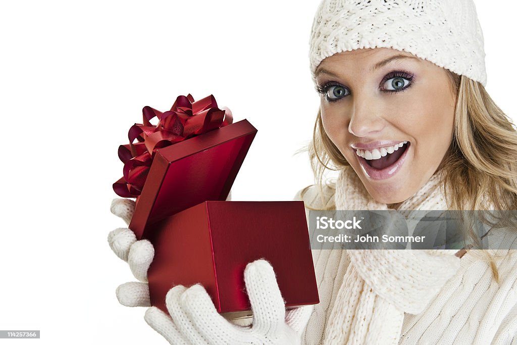 Woman opening a gift Woman shot on white opening a gift Christmas Stock Photo