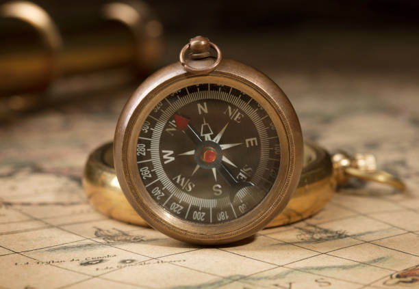 istock antique compass, magnifier, spyglass on map 1142573757