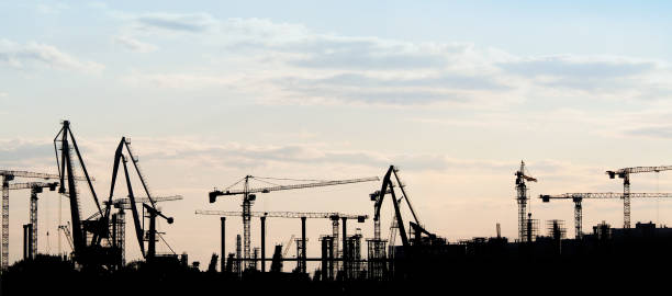 Silhouette of a construction site, dawn sky, panoramic view. Business growth and design and planning