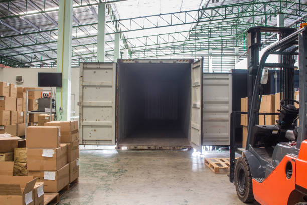 istock The forklift loading pallet with a forklift into a truck. 1142577345
